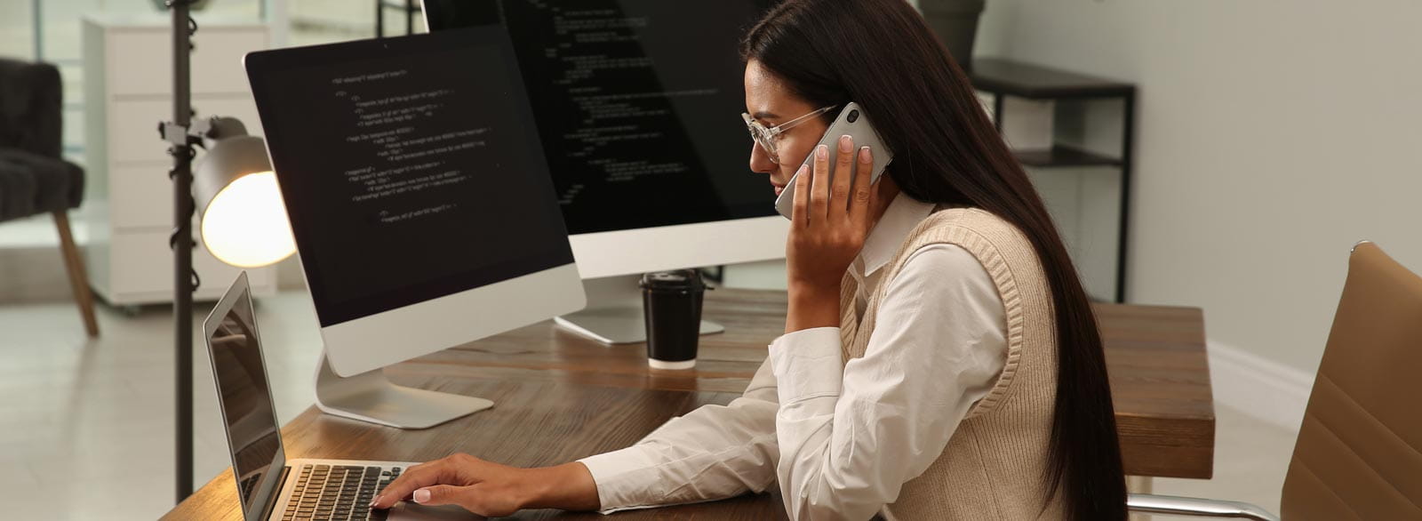 Woman on phone at workstation